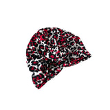 Leopard print headscarf with red and black patterns on a white background