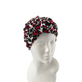 Patterned headscarf on a mannequin head against a white background