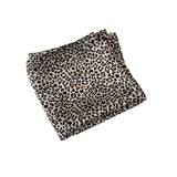 Folded fabric with leopard print pattern on a white background