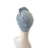 Light blue headscarf on a mannequin head against a white background