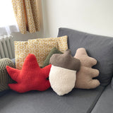 Decorative pillows with acorn shapes on a gray sofa