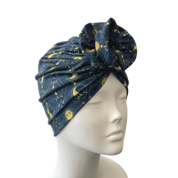 Blue patterned headscarf on a mannequin head against a white background