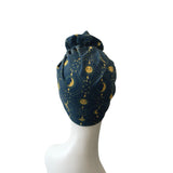 Navy blue headscarf with celestial pattern on a white mannequin head.
