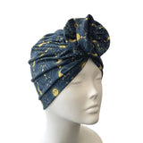 Blue patterned headscarf on a mannequin head against a white background