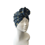 Blue patterned headscarf on a mannequin head against a white background