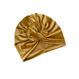 Gold velvet turban on a white background