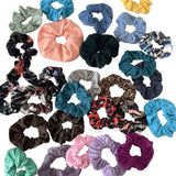 Collection of various colorful scrunchies on a white background