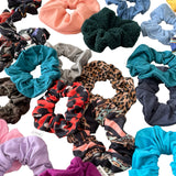 Collection of various colorful scrunchies on a white background