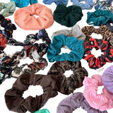 Collection of various colorful scrunchies on a white background