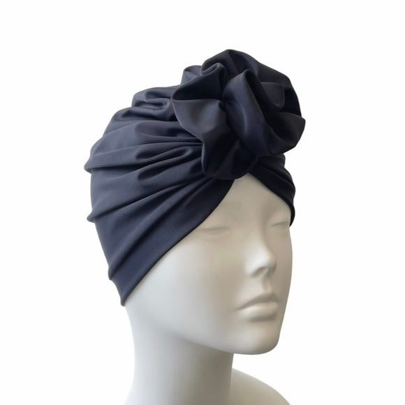 navy headscarf on a mannequin head against a white background