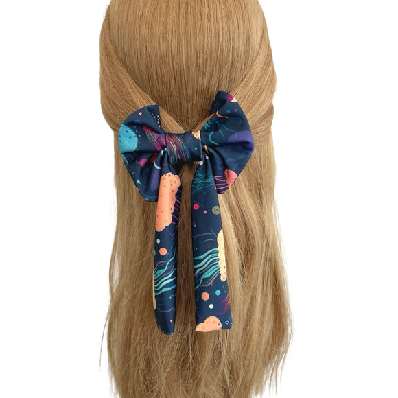 Colorful bow hair clip on a mannequin head with blonde hair against a white background