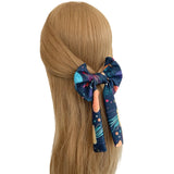 Navy blue hair scrunchie with space-themed design on a mannequin head with long blonde hair.