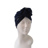 Navy blue lace headband on a mannequin head against a white background