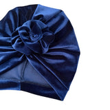 Blue velvet turban with a knot on a white background