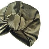 Green velvet turban with a knot on a white background