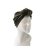 Olive green headscarf on a mannequin head against a white background