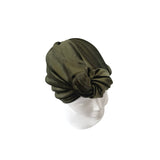 Green headscarf on a mannequin head against a white background