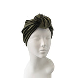 Green headband on a mannequin head against a white background