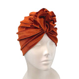 Orange headscarf on a mannequin head against a white background