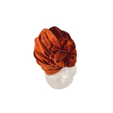 Brown velvet turban on a mannequin head against a white background