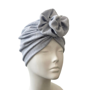 blue headscarf with a knot on a mannequin head against a white background