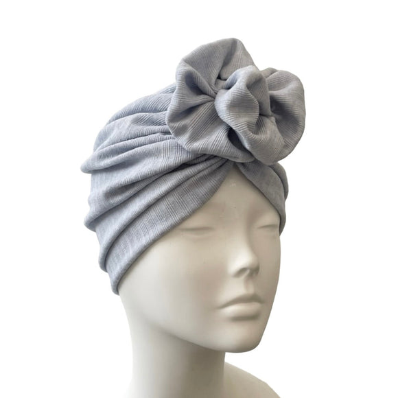 blue headscarf with a knot on a mannequin head against a white background