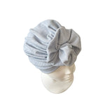 blue headscarf on a mannequin head against a white background