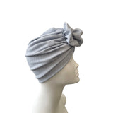 pale blue headscarf on a mannequin head against a white background