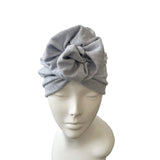 blue knotted headband on a mannequin head against a white background