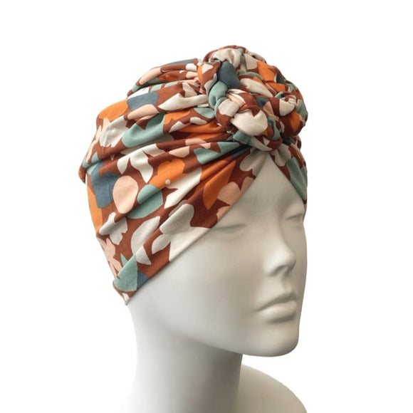 Patterned headscarf on a mannequin head against a white background