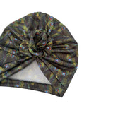 Turban with peacock feather pattern on a white background