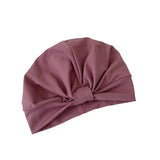 Pink turban with a knot on a white background