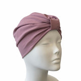 Pink turban on a mannequin head against a white background