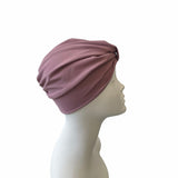 Mauve headscarf on a mannequin head against a white background