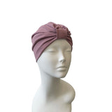 Mauve headscarf on a mannequin head against a white background