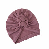Mauve turban with a knot on a white background