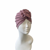 dusky pink headscarf on a mannequin head against a white background