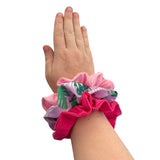 Hand wearing a colorful scrunchie on a white background ireland