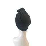 Black headscarf on a mannequin head against a white background