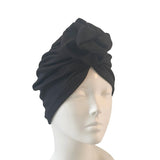 Black turban on a mannequin head against a white background