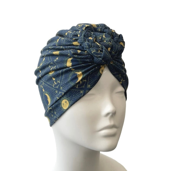Blue patterned headscarf on a mannequin head against a white background