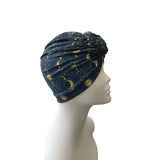 Blue headscarf with gold patterns on a mannequin head against a white background