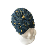 Blue patterned headscarf on a mannequin head against a white background