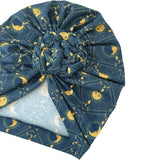 Blue headscarf with yellow moon and star pattern on a white background