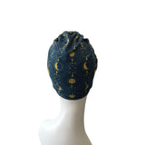 Blue patterned headscarf on a mannequin head against a white background