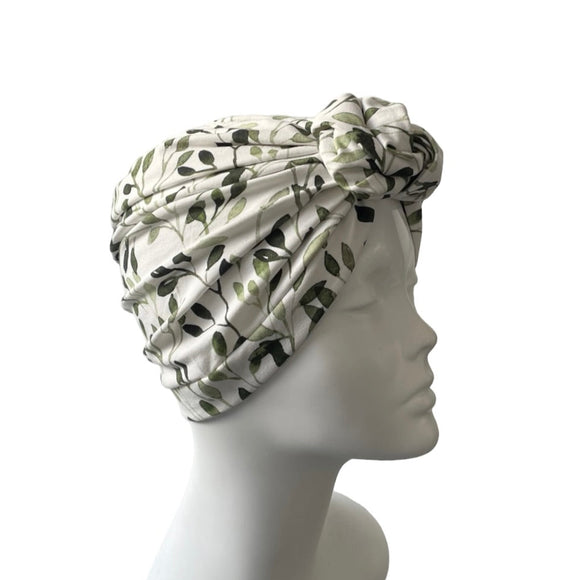 Turban with leaf pattern on a mannequin head against a white background