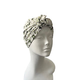 Turban with leaf pattern on a mannequin head against a white background