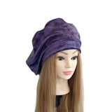 Purple headscarf on a mannequin head with long hair against a white background