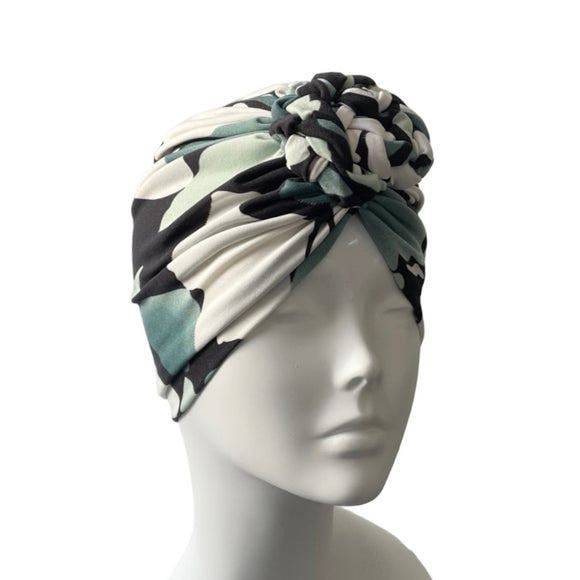 Turban with black and white pattern on a mannequin head against a white background