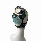 Camouflage-patterned headscarf on a mannequin head against a white background